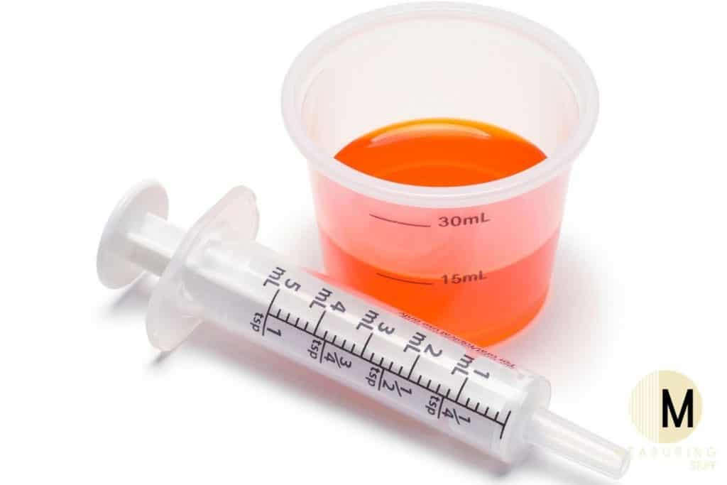 medicine cup with syringe