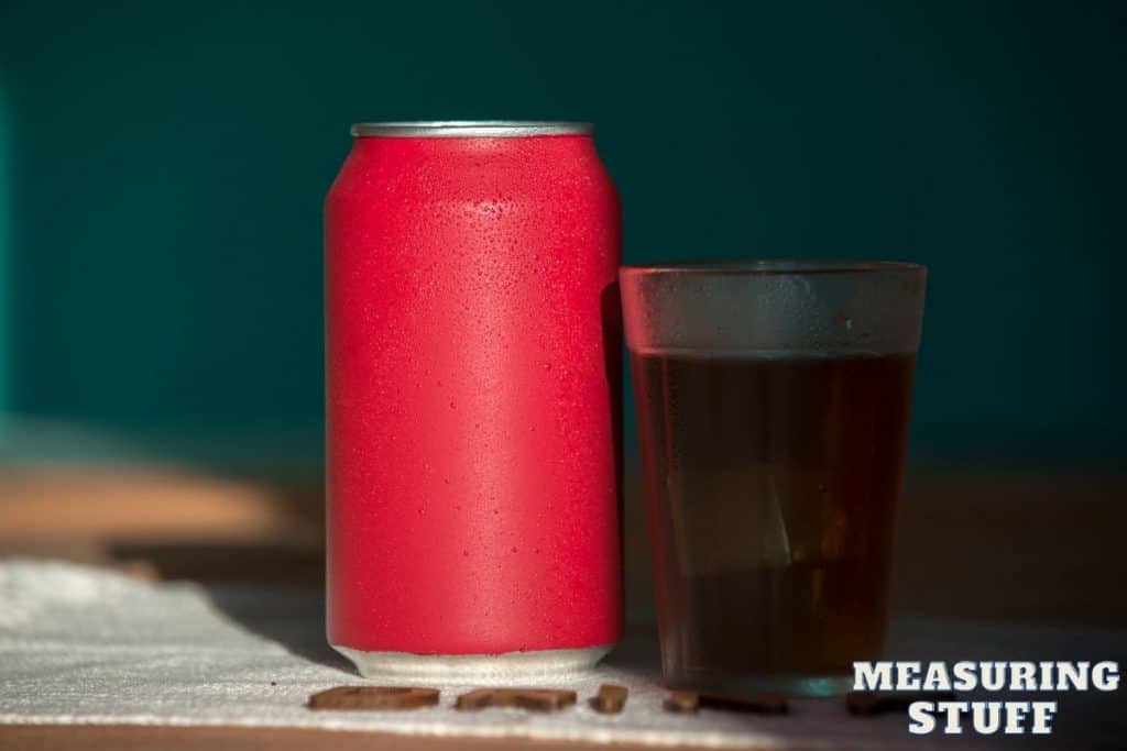 red soda can and glass