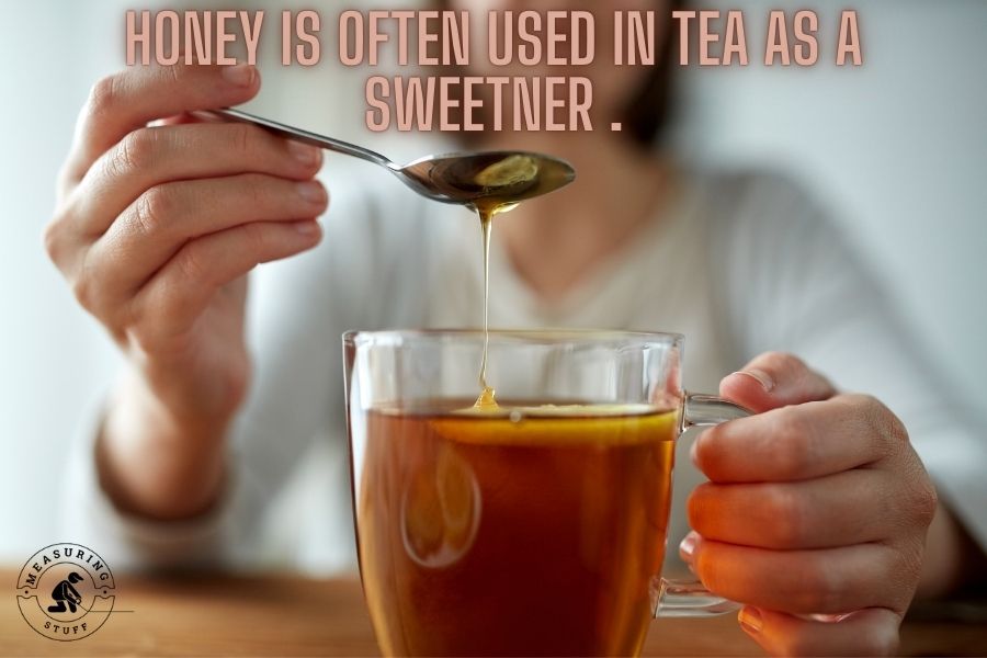 Honey poured into tea