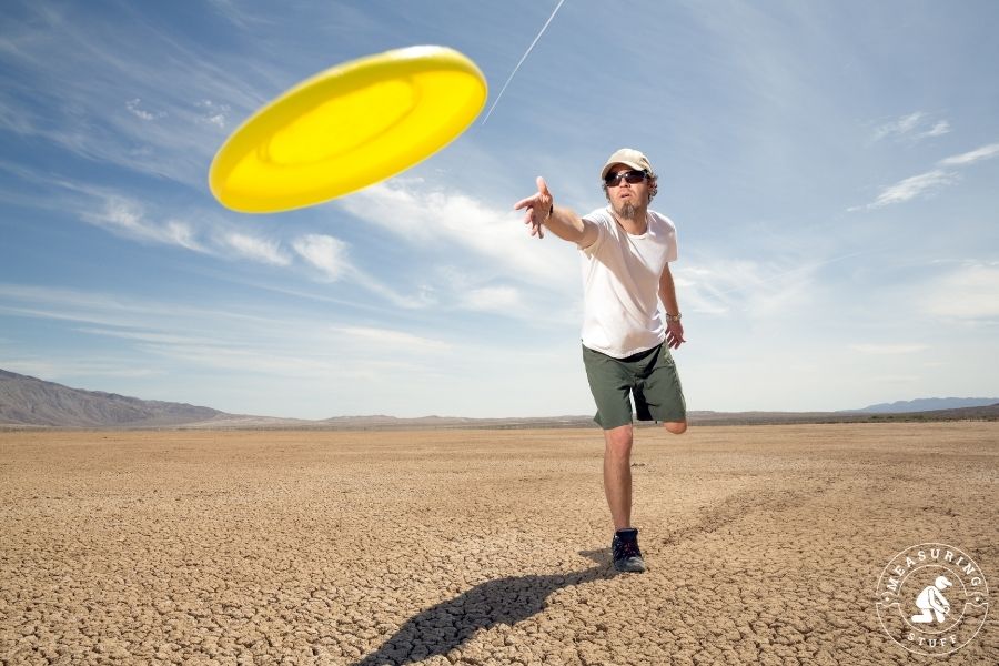 Man tossing a yellow frisbee