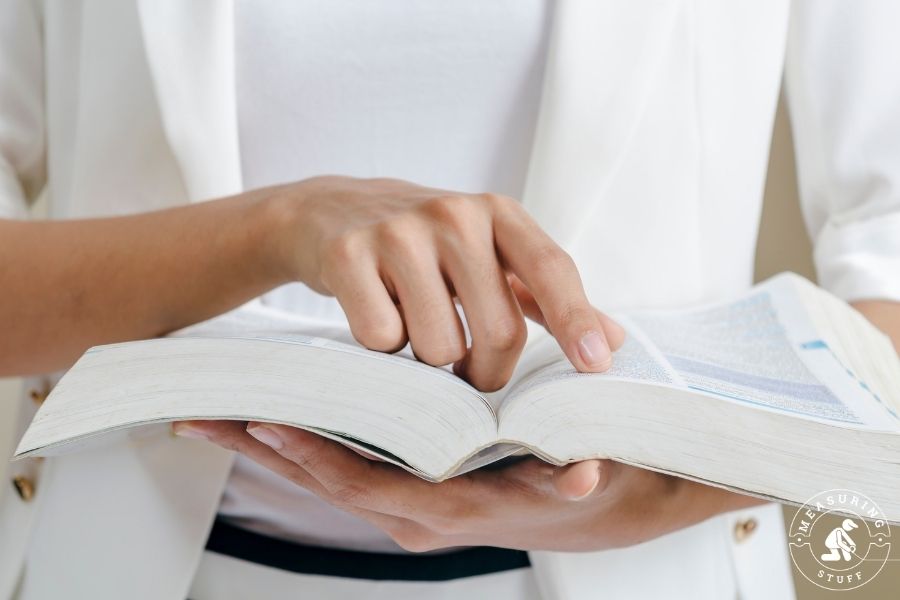 person scanning a book with finger