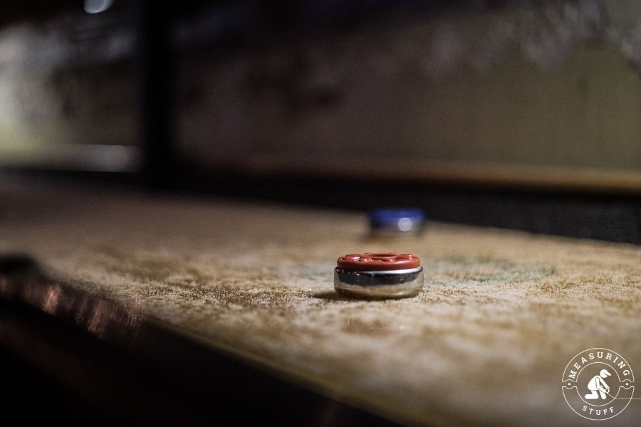 shuffleboard top with red puck 