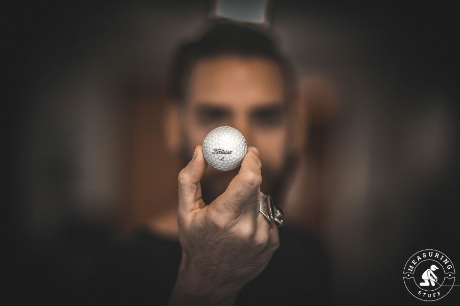 man holding Titleist 4