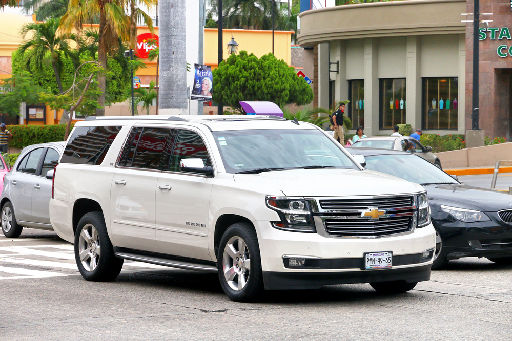 White chevrolet suburban on road