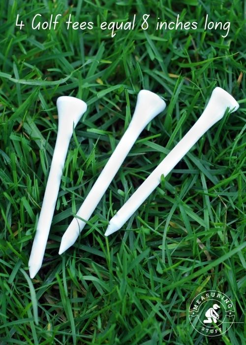 white golf tees on grass