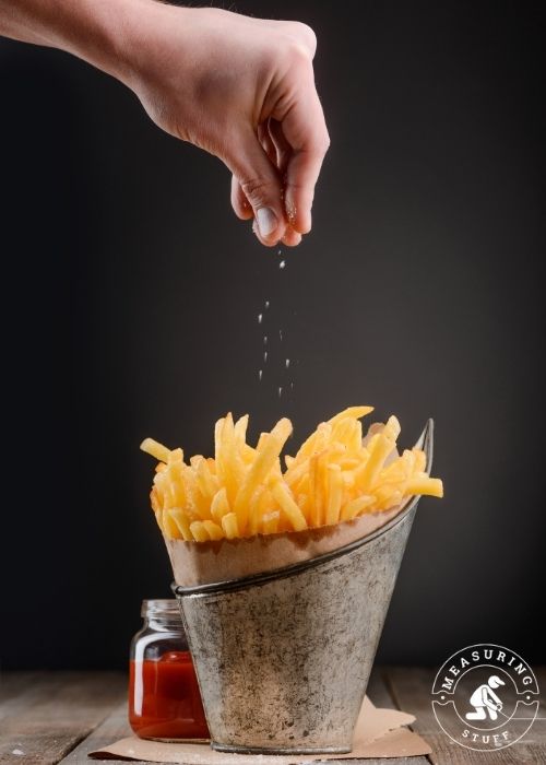 basket of fries and pinch of salt