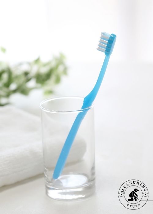blue toothbrush in a glass