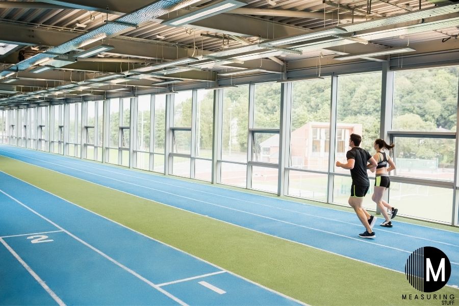 man and woman running on track