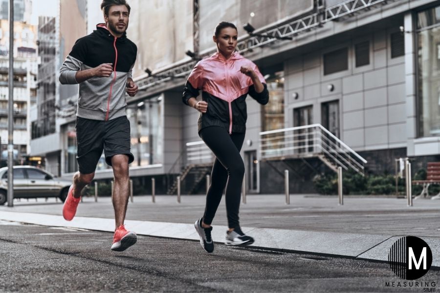 man and woman jogging on street