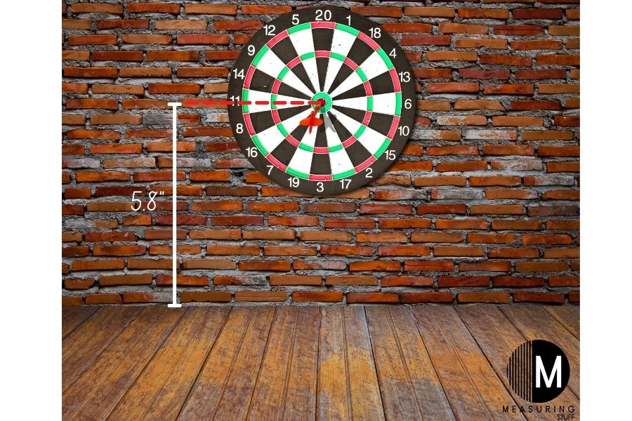 dart board on brick wall showing height