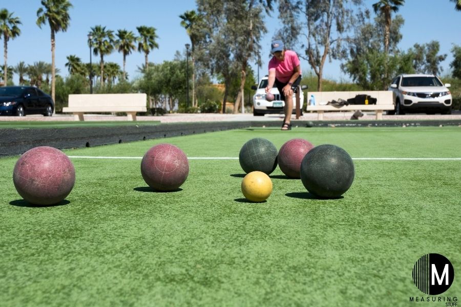 man rolling bocce ball