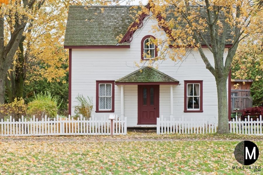 white house with fenced yard