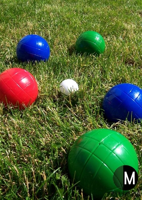 several bocce balls on grass