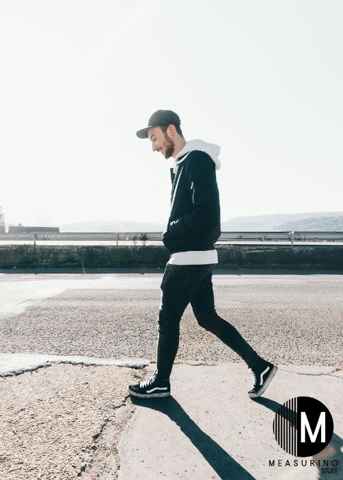 man walking on pavement