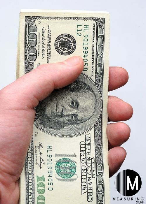 holding a 100 dollar bill