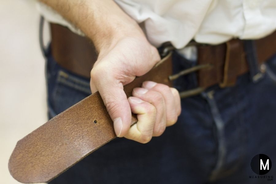 man tightening a belt