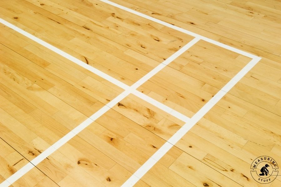 badminton wooden surface with white tape