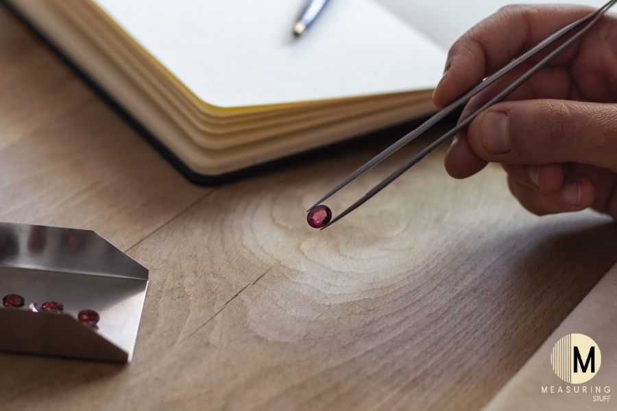 gemologist with small ruby