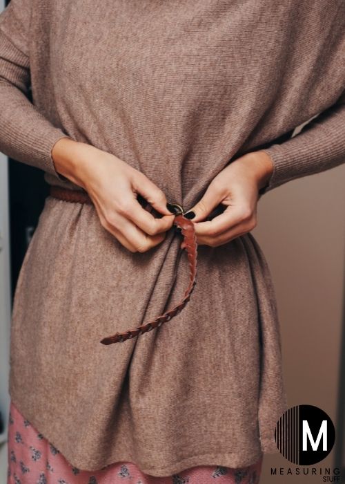 woman trying on brown belt