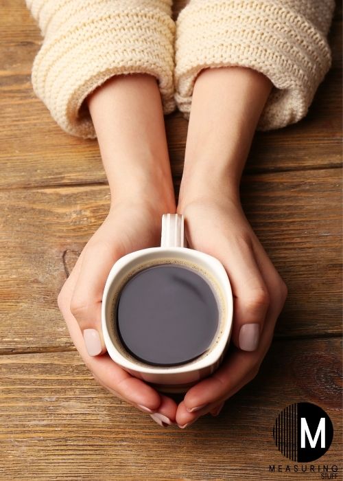 woman holding cup of coffee