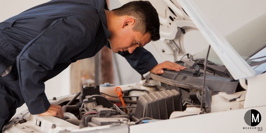 car mechanic inspecting vehicle
