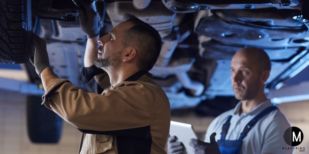 mechanic inspecting car tire