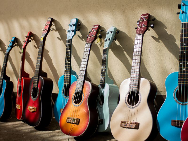 several guitars leaning on a wall