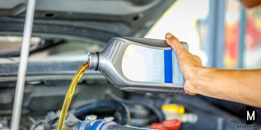 pouring oil into car engine