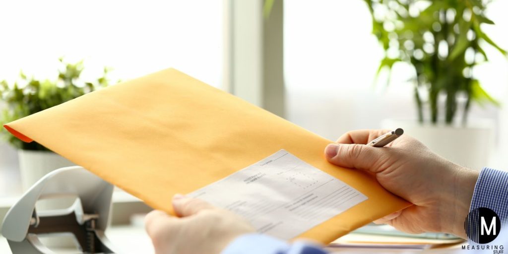 man holding A4 envelope