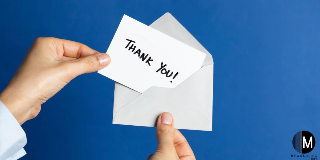 holding a thank you card