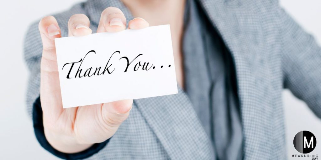 man holding thank you card