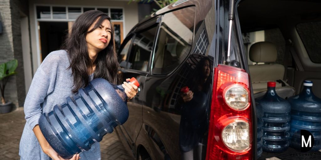 woman lifting bottle of water