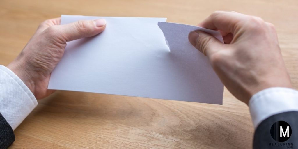 person tearing paper