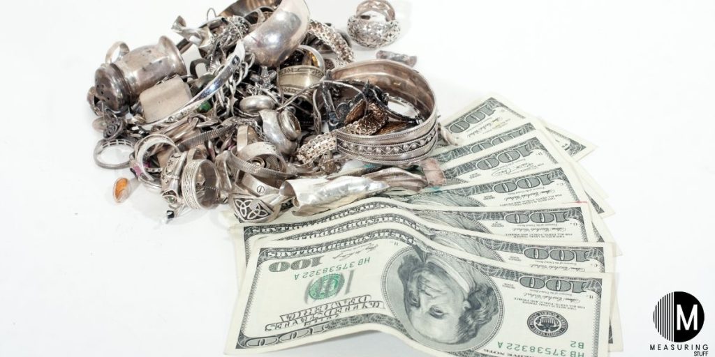 pieces of sterling silver with 100 dollar bills