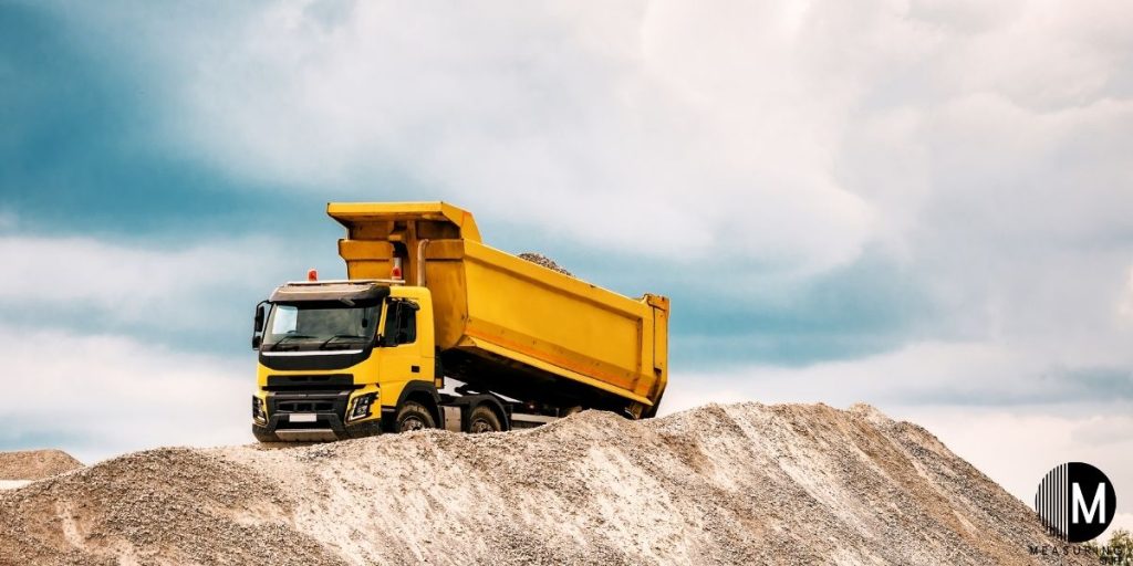 gravel truck on mound of gravel