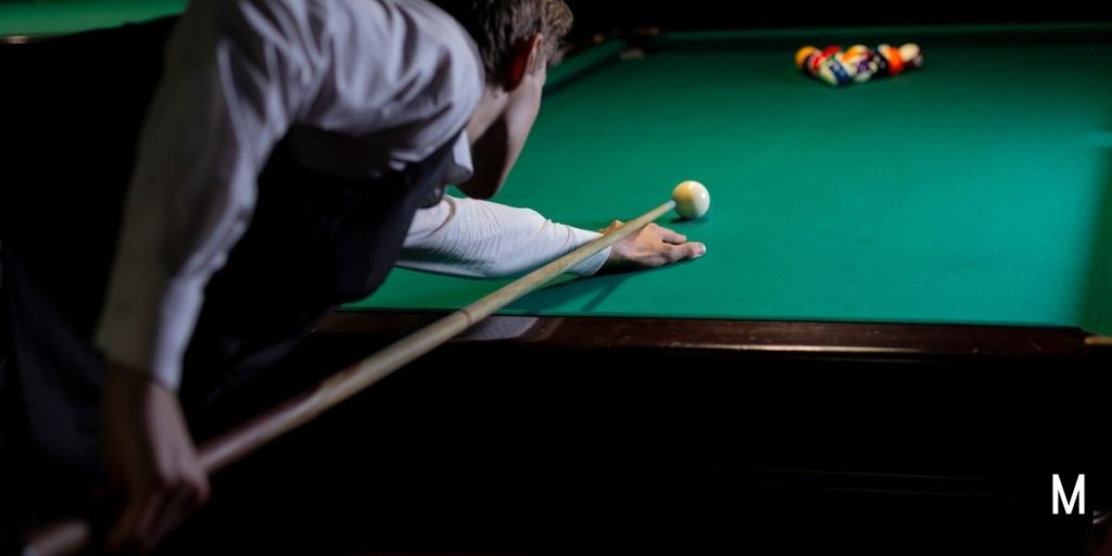 man playing pool