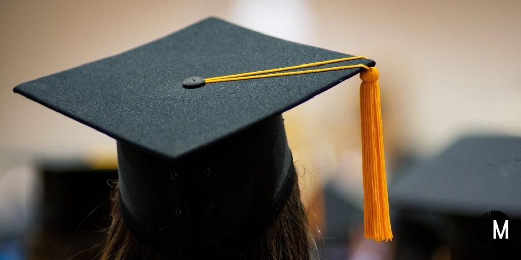 graduation cap with orange tassel