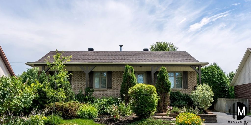 bungalow house surrounded by shrubs