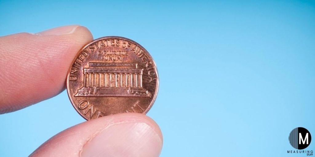 person holding a penny