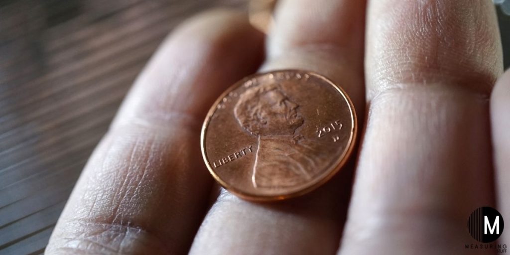 single penny coin in hand