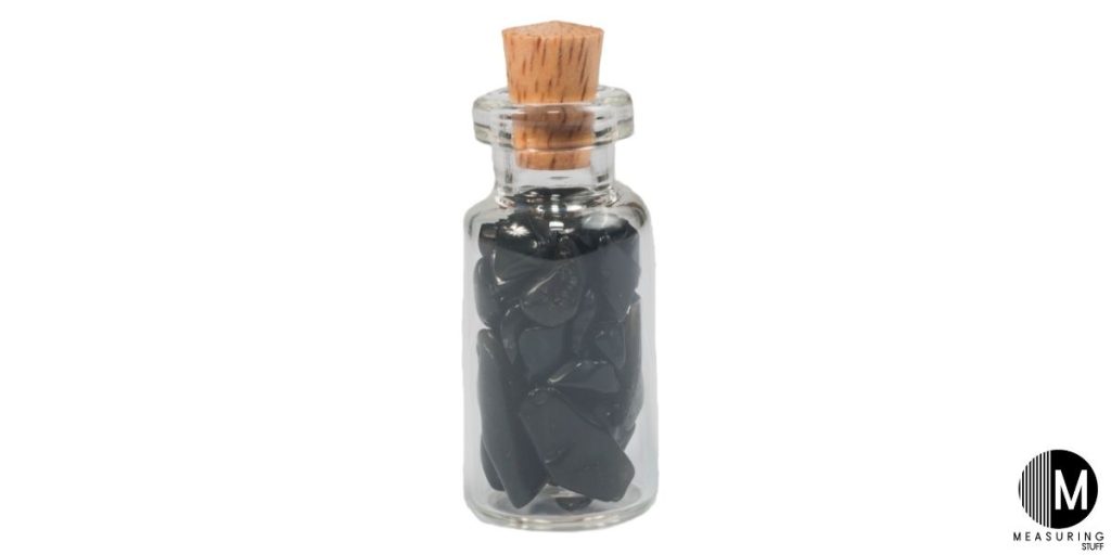 obsidian stone in glass jar