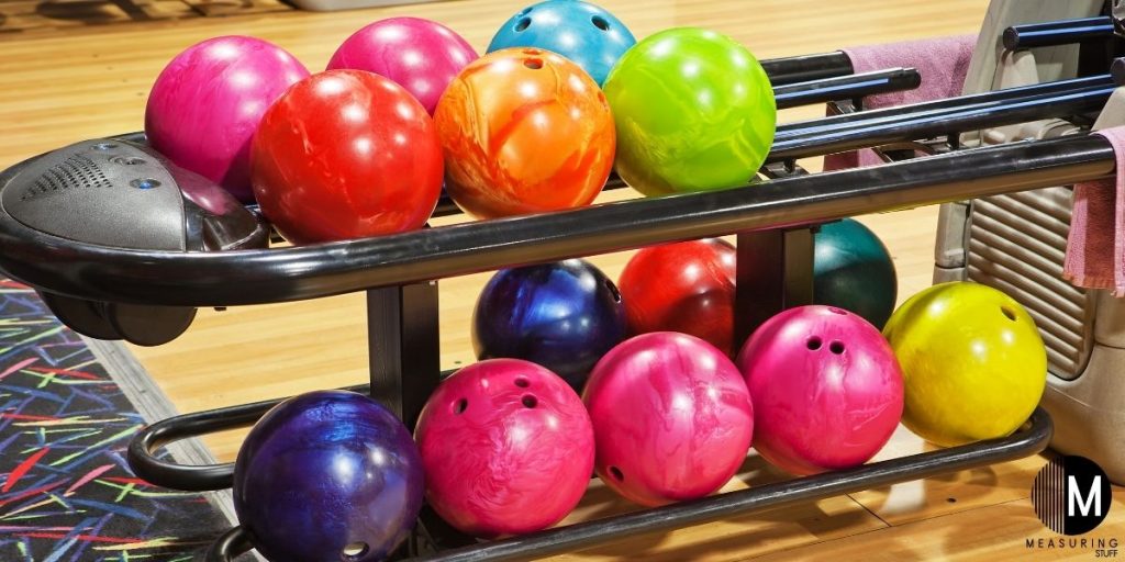 several bowling balls on rack