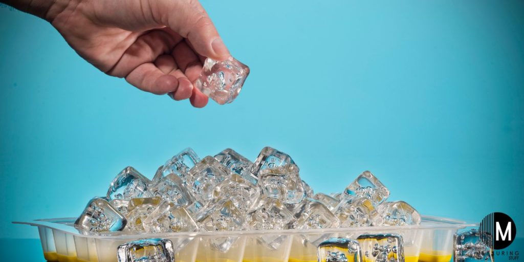 adding ice cube to a tray