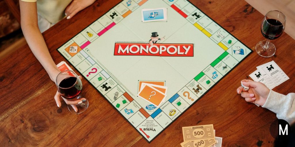 playing Monopoly with glasses of wine