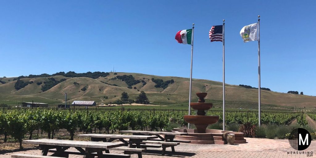 3 flag poles at a park