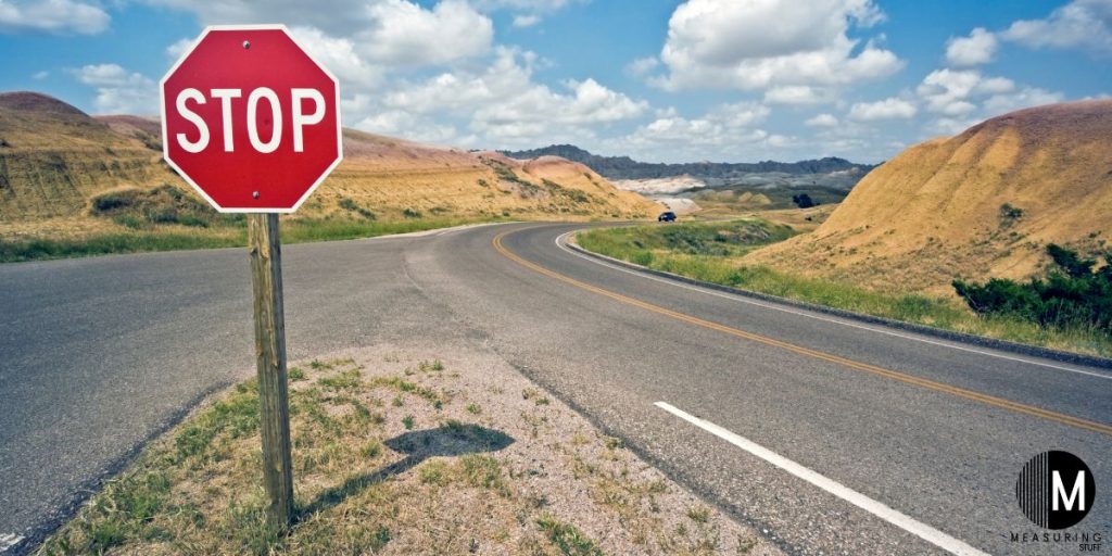 stop sign next to highway