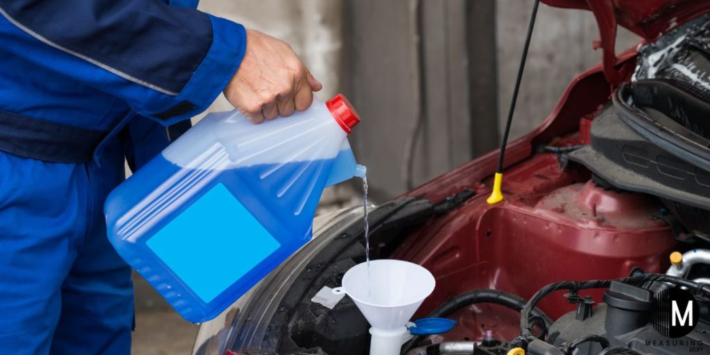 pouring washer fluid in car