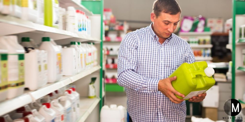 man holding liquid fertilizer