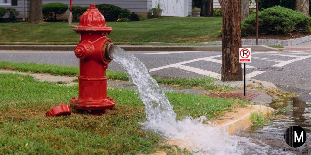 fire hydrant pouring water onto street