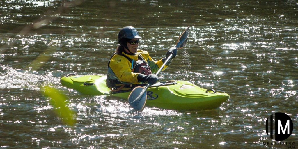 person in a kayak on turbulent water